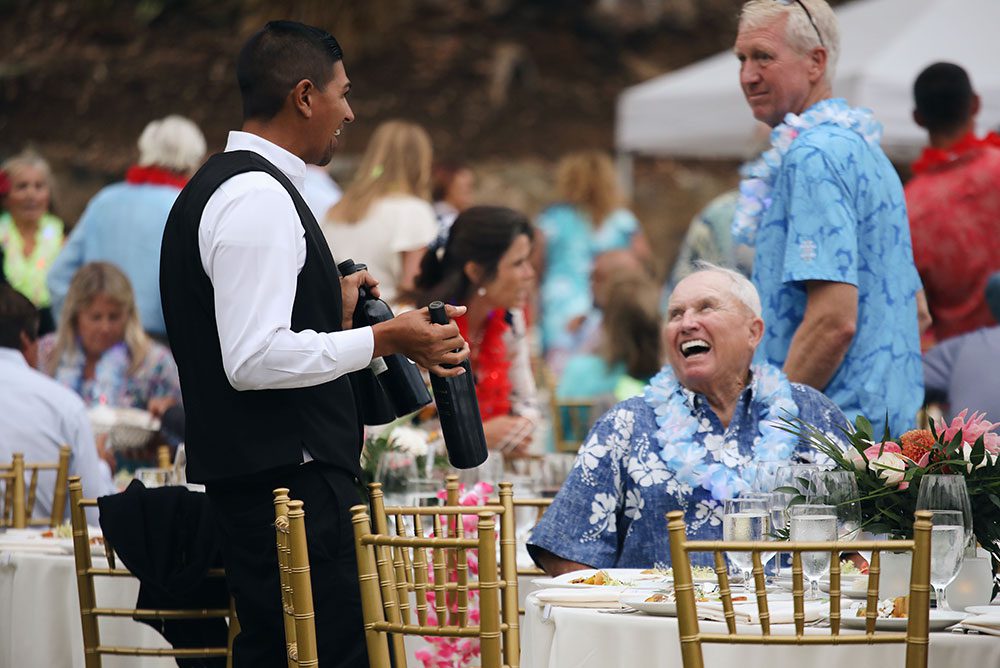 An older man shares a laugh with one of the event staff (Catalinaville, 2022)